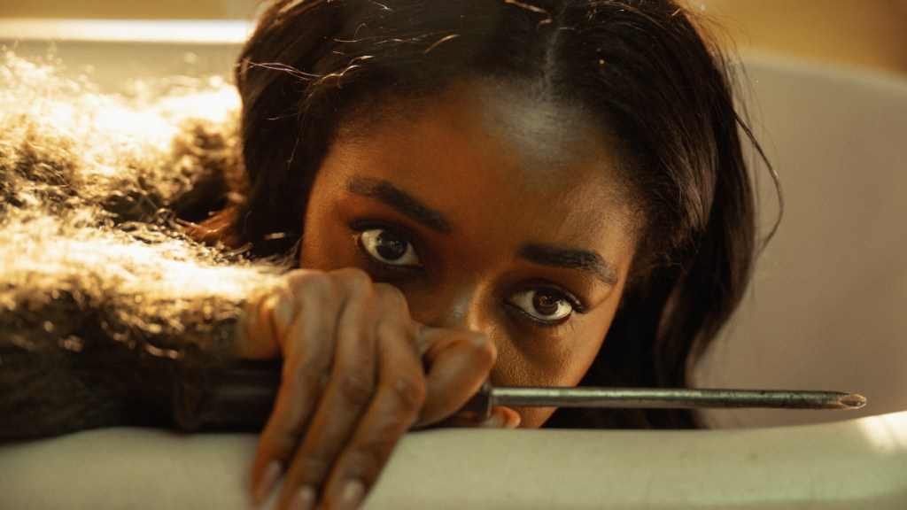 Ayo Edebiri holds a screwdriver in "Opus."