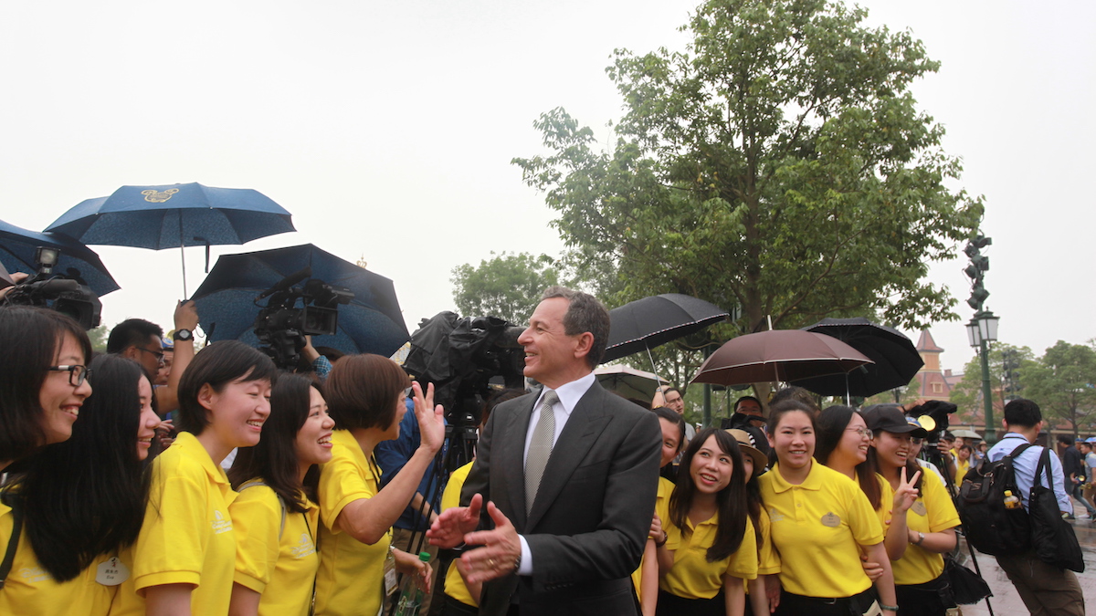 Disney's Chief Executive Officer Bob Iger poses with volunteers at Shanghai Disney Resort during grand opening on June 16, 2016 in Shanghai, China. Shanghai Disney Resort held the opening ceremony and welcomed tourists on Thursday. (Photo by Visual China/Getty Images)