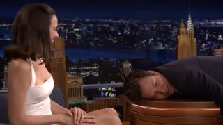 Margaret Qualley Convinces Jimmy Fallon to Interview Her While Laying Face-Down on His Desk | Video