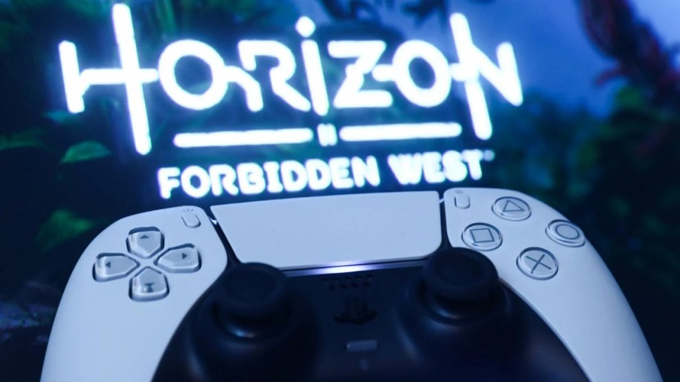 PlayStation DualSense controller and Horizon Forbidden West on PlayStation Store displayed on a tv screen are seen in this (Getty Images)