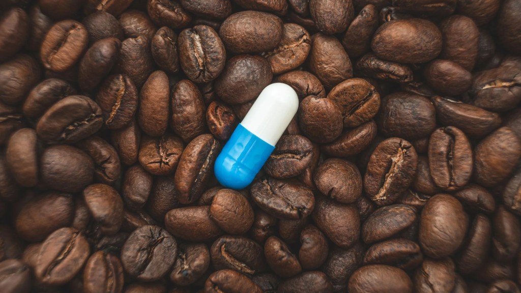 Pill on the background of coffee beans. (Getty Images)