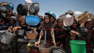 Crowds form as Palestinians, including children, line up in Gaza City to receive food distributed by a charity amid ongoing Israeli blockade and attacks on Gaza. (Credit: Ali Jadallah/Anadolu via Getty Images)