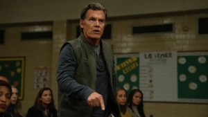 Josh Brolin stands in front of a crowd pointing at the floor