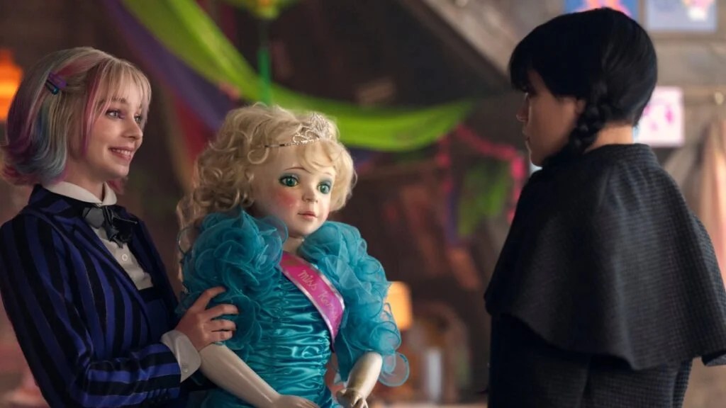 Emma Myers and Jenna Ortega in "Wednesday" Season 2, Myers holds a blonde doll